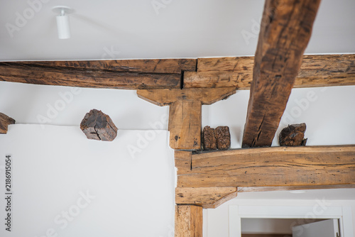 Rustic wooden ceiling beam in modern apartment interior