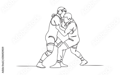 фотографія Two young male wrestlers in a competitive match grappling and fighting in a spor
