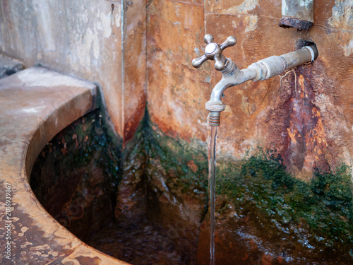 Canvas Print Natural healing mineral spring flowing from a metal tap in Bardejov Spa, Slovakia, representing spa treatment, drinking cure, balneotherapy, mineral water and health tourism