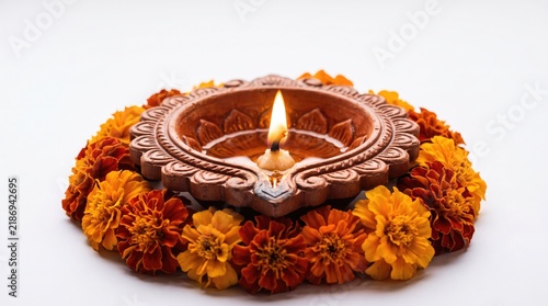 Traditional indian diya lamp surrounded by vibrant marigold flowers for diwali celebration and religious rituals