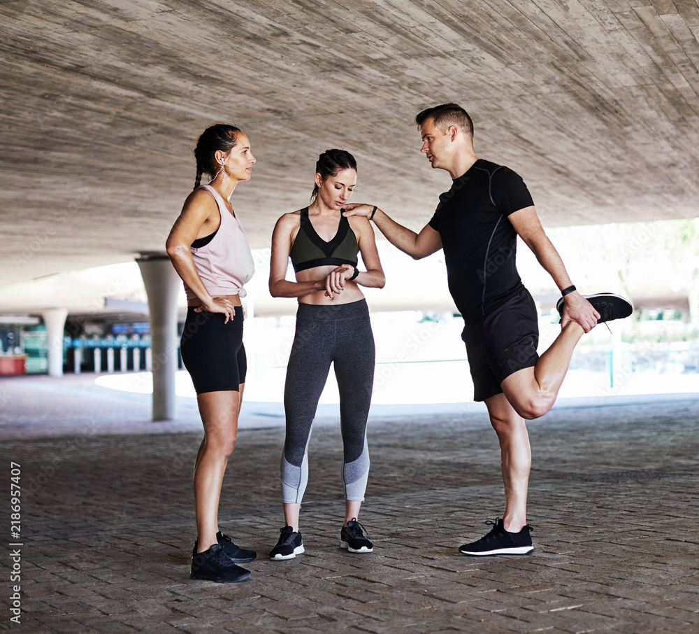 Fototapeta premium Runner, rest and smart watch with people in city for workout team, health and training discussion. Running group, conversation and timer with exercise club for athlete friends, fitness and support
