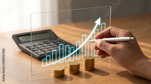 Hand drawing financial growth chart on glass with coins and calculator on desk