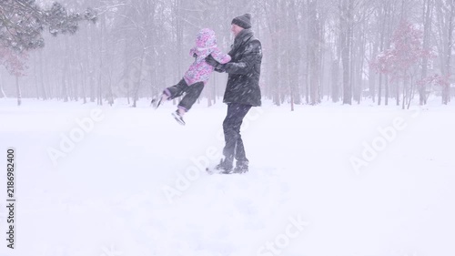 Father winter activity. Toddler enjoying playful lifting outdoors. Active fatherhood concept.