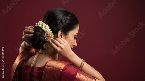 Woman Arranging Flowers in Hair for Traditional Beauty