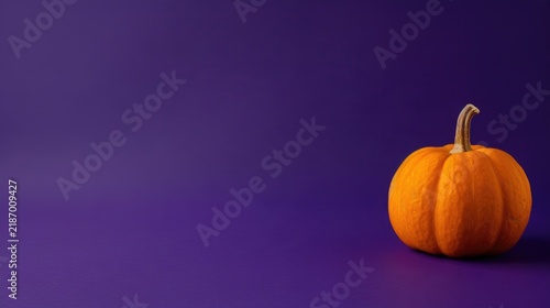 Orange pumpkin on purple Halloween copy space