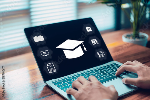 Professional using laptop with education and AI icons on screen, representing online learning, digital education, artificial intelligence, training, career development, and modern technology.
