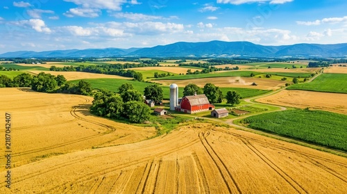 Rolling hills and a vast agricultural landscape under a sunny sky