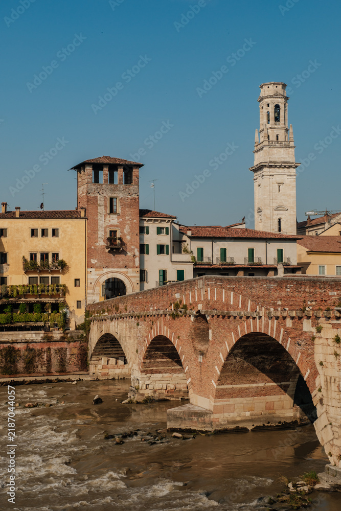 Fototapeta premium Discover the charming architecture and historic bridges along the river in Verona, Italy