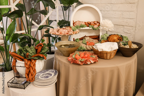 Festive buffet table with traditional meats salads and elegant event decor