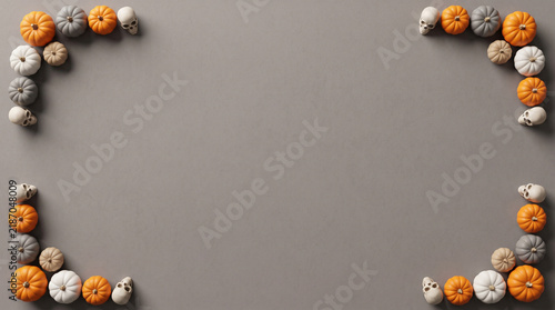 Halloween mixed mini pumpkins and skulls corner layout flat lay on neutral grey background, spooky banner design with copy space