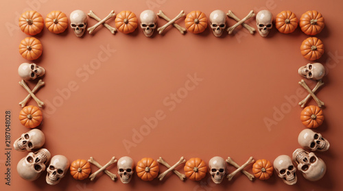 Halloween pumpkins, skulls and crossbones border flat lay on terracotta background, spooky banner design with copy space