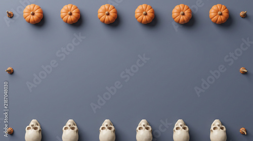 Halloween mini pumpkins and skulls top-bottom border flat lay on charcoal background, spooky banner design with copy space