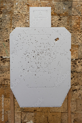 Obraz na płótnie White tactical silhouette shooting paper target heavily peppered with multiple s