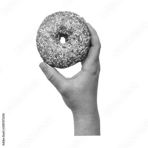 Cuadro en lienzo A hand is holding a donut covered in colorful sprinkles