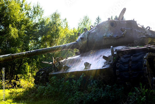 a broken rusting tank in the nature close up