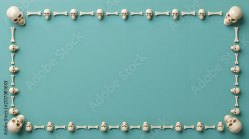 Halloween skull border on teal background, spooky skeleton frame with copy space, decorative bone pattern for holiday invitations