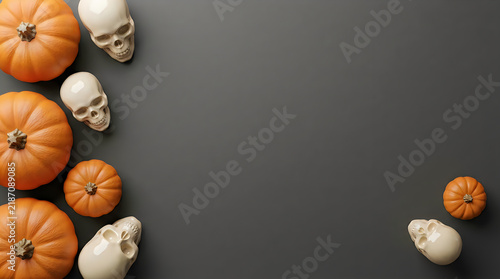 Halloween flat lay with orange pumpkins and white skulls, spooky autumn border on dark background, seasonal holiday frame
