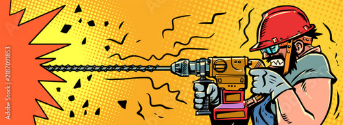 A man drills with a hammer drill. Advertisement for a construction site and hardware store. Heavy physical labor.