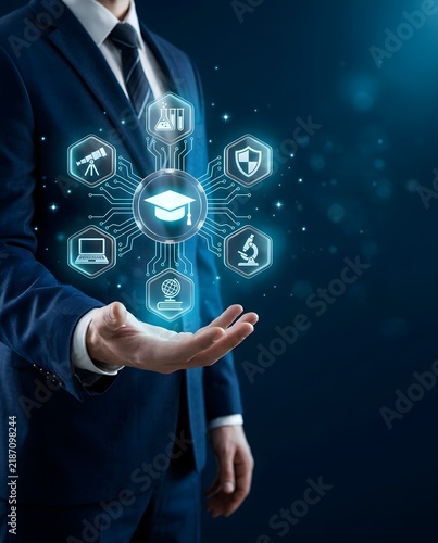 Businessman holding glowing graduation cap and education icons on digital circuit board interface representing e-learning, online education technology, STEM research, and academic knowledge management