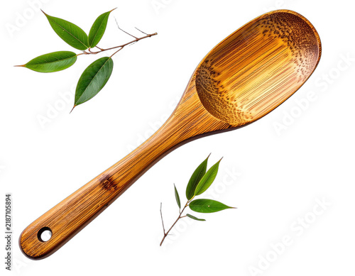 A close-up of a bamboo spoon with green leaves on a black background.