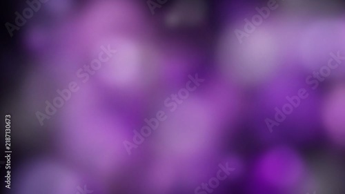 Purple bokeh lights glowing in the dark as an abstract background