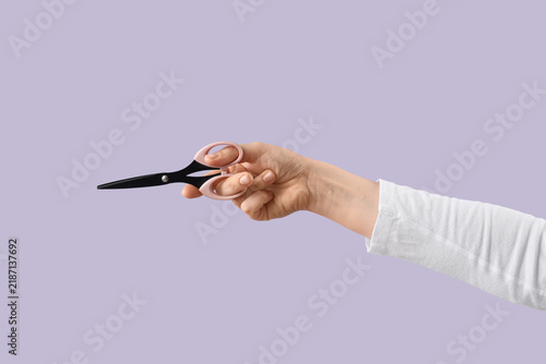 Принти на полотні Cost cutting and budget reduction, hand holding scissors to represent financial