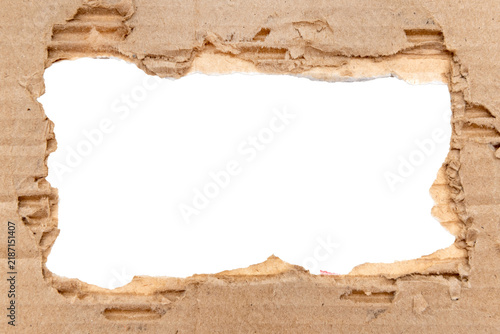Hole in torn cardboard on white background. Cardboard frame with a hole