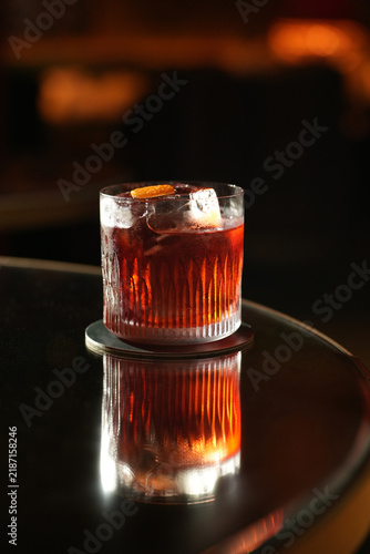 Classic Negroni Cocktail with Large Ice Cube and Orange Peel Garnish