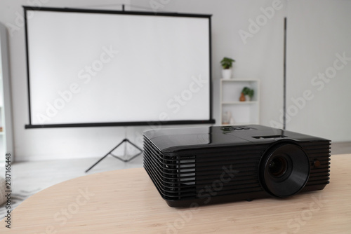 Video projector on dining table in light room, closeup