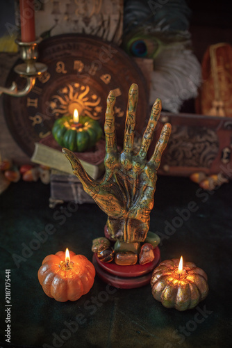 Bild auf Leinwand Vintage palmistry hand sculpture with astrological symbols on mystical altar wit
