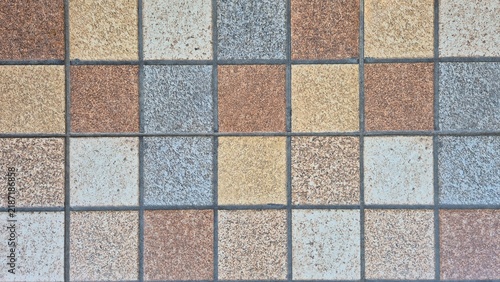 Foto Decorative square tile flooring with a repeating geometric pattern in earthy brown, beige, gray, and blue tones