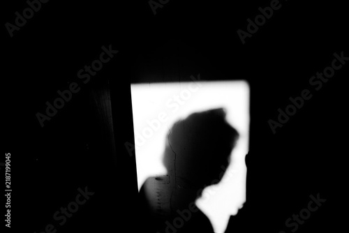 Close up side view black and white shadow of portrait a man on the dirty wall