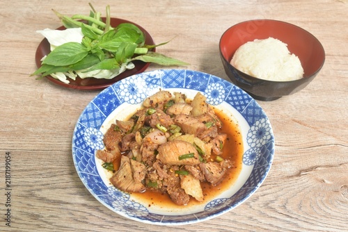 Thai spicy slice beef meat salad on plate eat couple fresh basil and sticky rice 