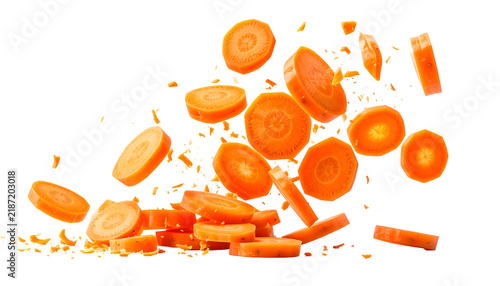 Sliced carrots mid-air, isolated on black background, showcasing bright orange color