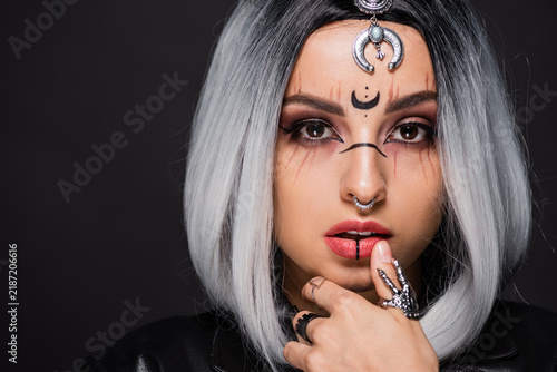 Bild auf Leinwand Young woman embraces spooky elegance as a witch for Halloween celebration