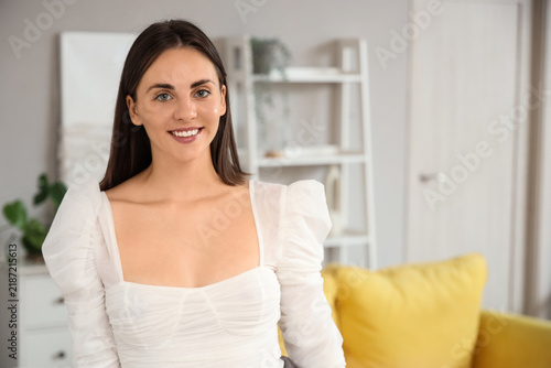 Beautiful young woman smiling at home