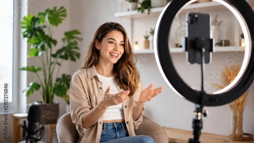 Smiling woman filming video with ring light
