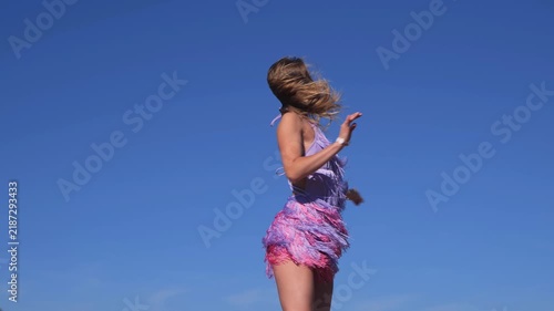 Tanned Female Model In A Flirty Short Summer Dress Posing On A Riverside Beach. Enjoying Sensual Dance Movements And Romantic Summer Relaxation.