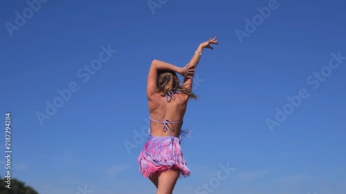 Smiling Tanned Woman Posing In A Short Off Shoulder Dress Near The River. Enjoying Romantic Dance Movements And A Carefree Summer Holiday.