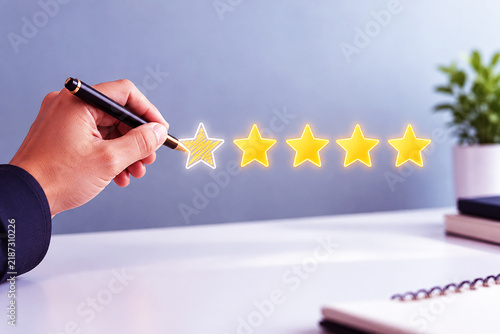 Hand drawing a five star rating on a digital screen