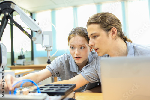 automation machine engineer student study and inspection control robot arm machine in university or factory workshop. AI robot technology are new innovation trend for manufacturing in industry