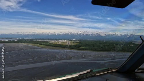 Anchorage, Alaska - approach and go around from Pilots point of view (POV) at Ted Stevens Anchorage International Airport on Runway 25R, Cockpit View with mountain landscape in the background, footage