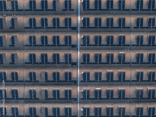 Aerial view of the geometric roof structure of a building in the EUR district, featuring repeating patterns of skylights and concrete surfaces in Rome, Lazio, Italy.