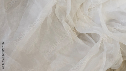 Cuadro en lienzo Wide horizontal abstract background of shimmering cream and beige organza fabric