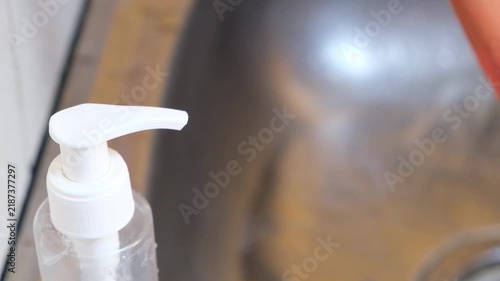 Liquid soap pumping on hands slow motion 4K