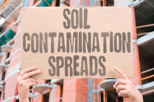 фотографія "Soil contamination spreads" Agricultural land polluted by industrial activity