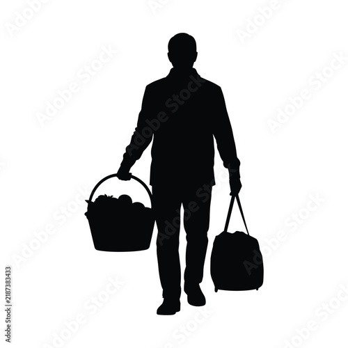 Man silhouette carrying picnic basket and duffel bag walking home after shopping trip