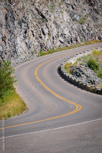 Curving road winds through rocky mountain terrain