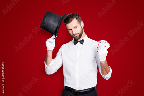 Photography Portrait of virile harsh illusionist with stubble and modern hairstyle, holding