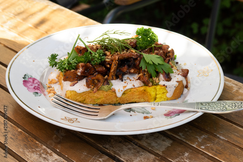 toast with mushrooms with sauce and herbs